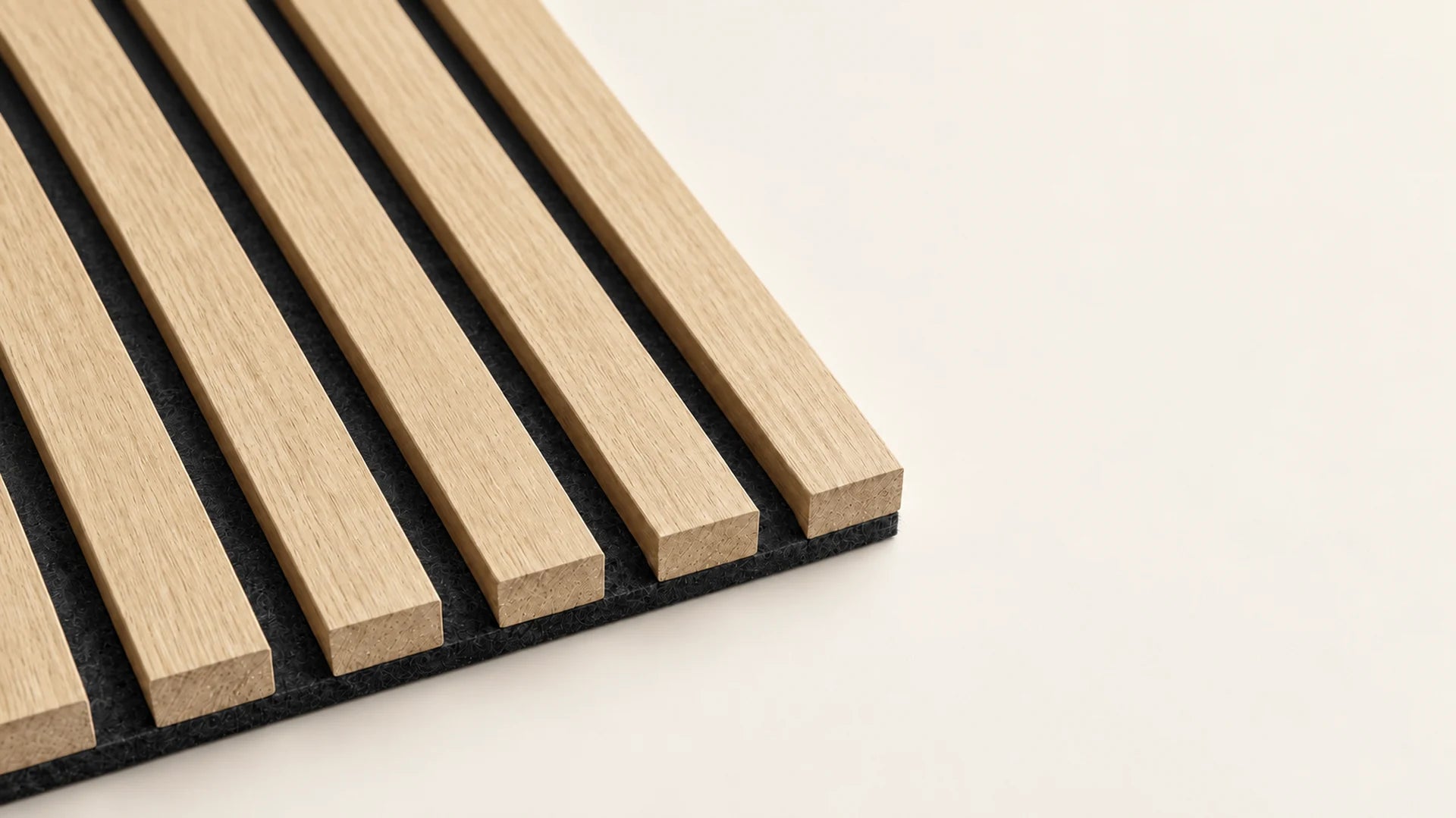 A close-up of Light Oak slats, showing the fine wood grain, squared ends and dark felt backing.